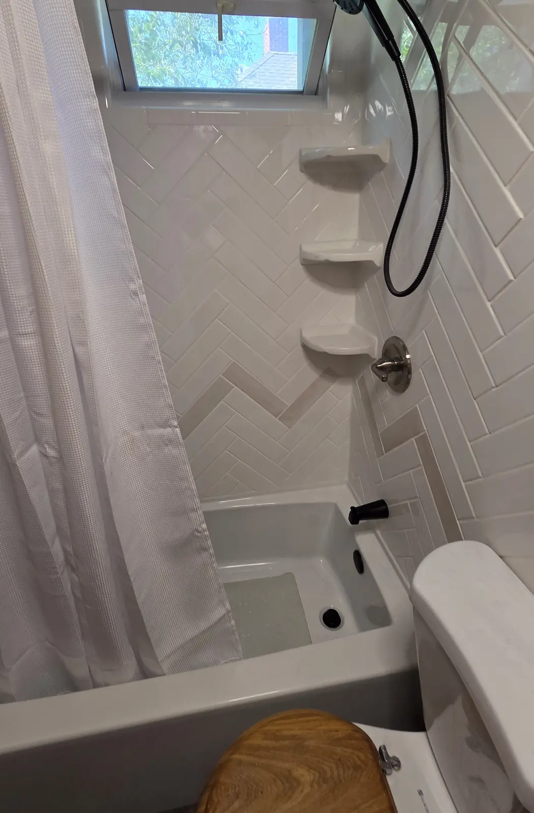 Ugly Kitchen bathroom with herringbone tile and soaking tub