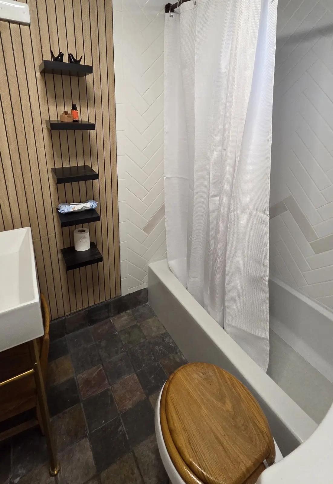 Ugly Kitchen bathroom with wood slat accent wall and slate floor