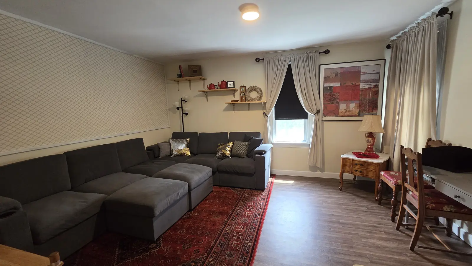 Ugly Kitchen living room with sectional, desk and dining chairs