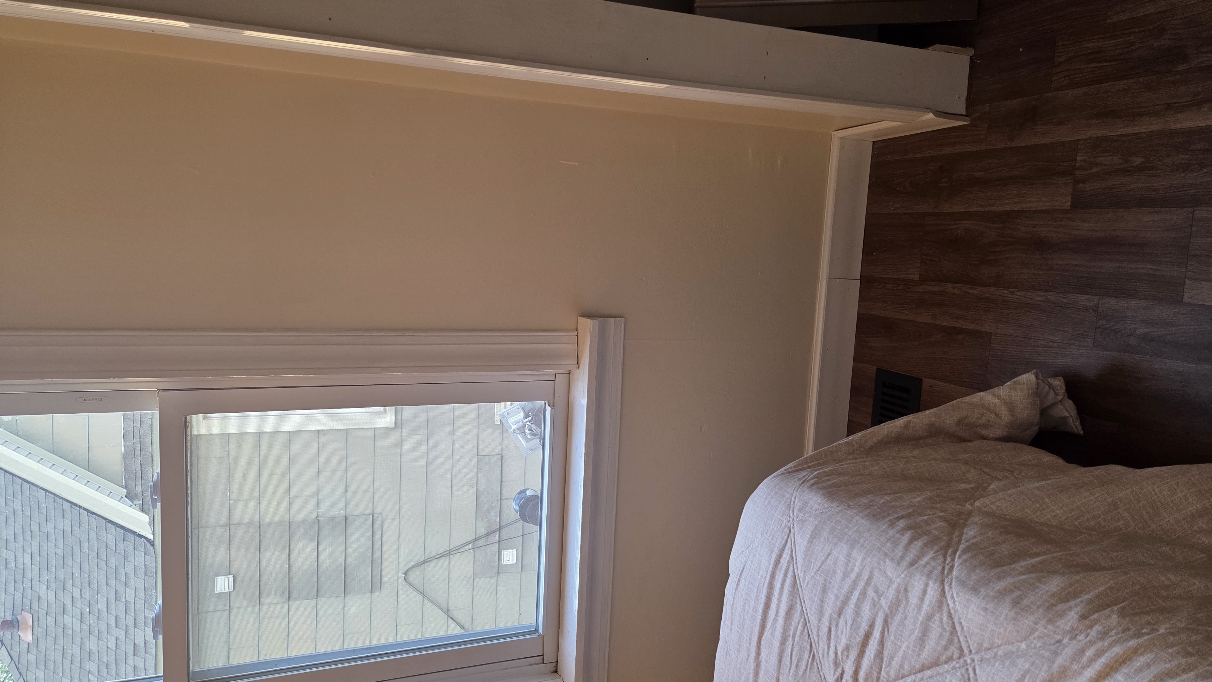 Ugly Kitchen bedroom with wood accent wall and window