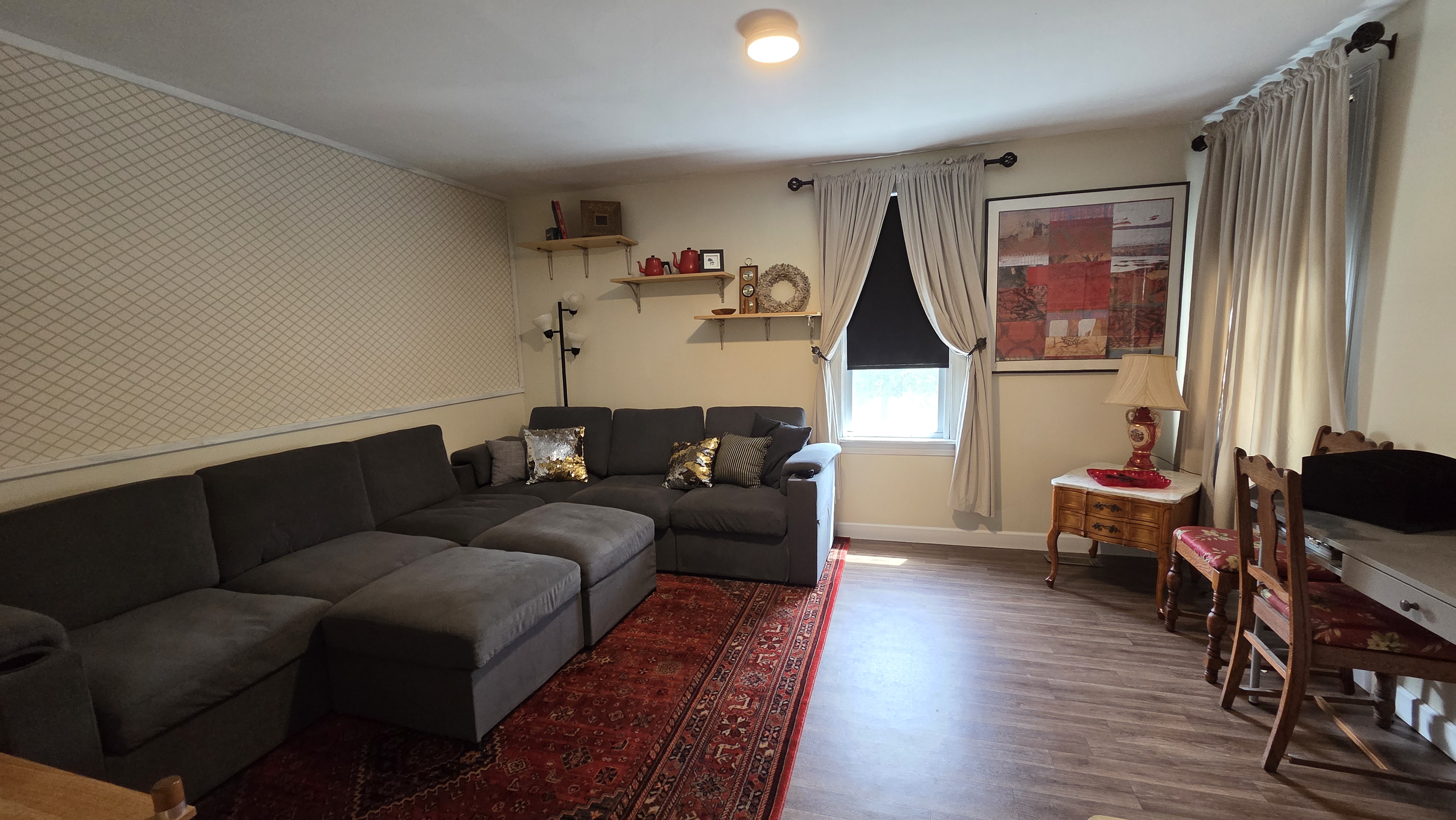 Ugly Kitchen living room with sectional, desk and dining chairs